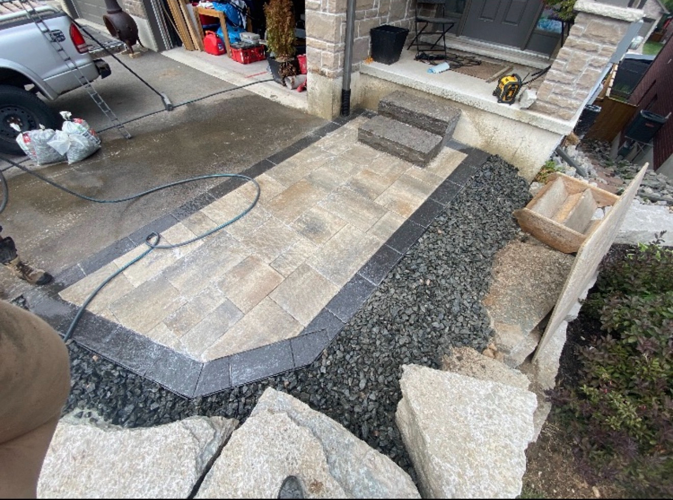 Interlocking stone walkway alongside a garage