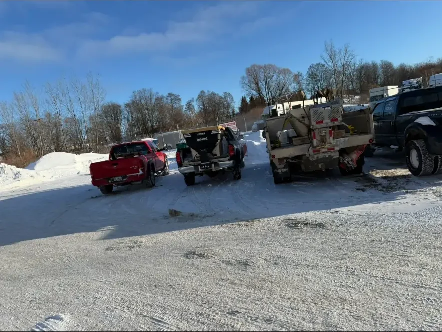NS Services trucks fitted with salt spreaders at a snowy yard